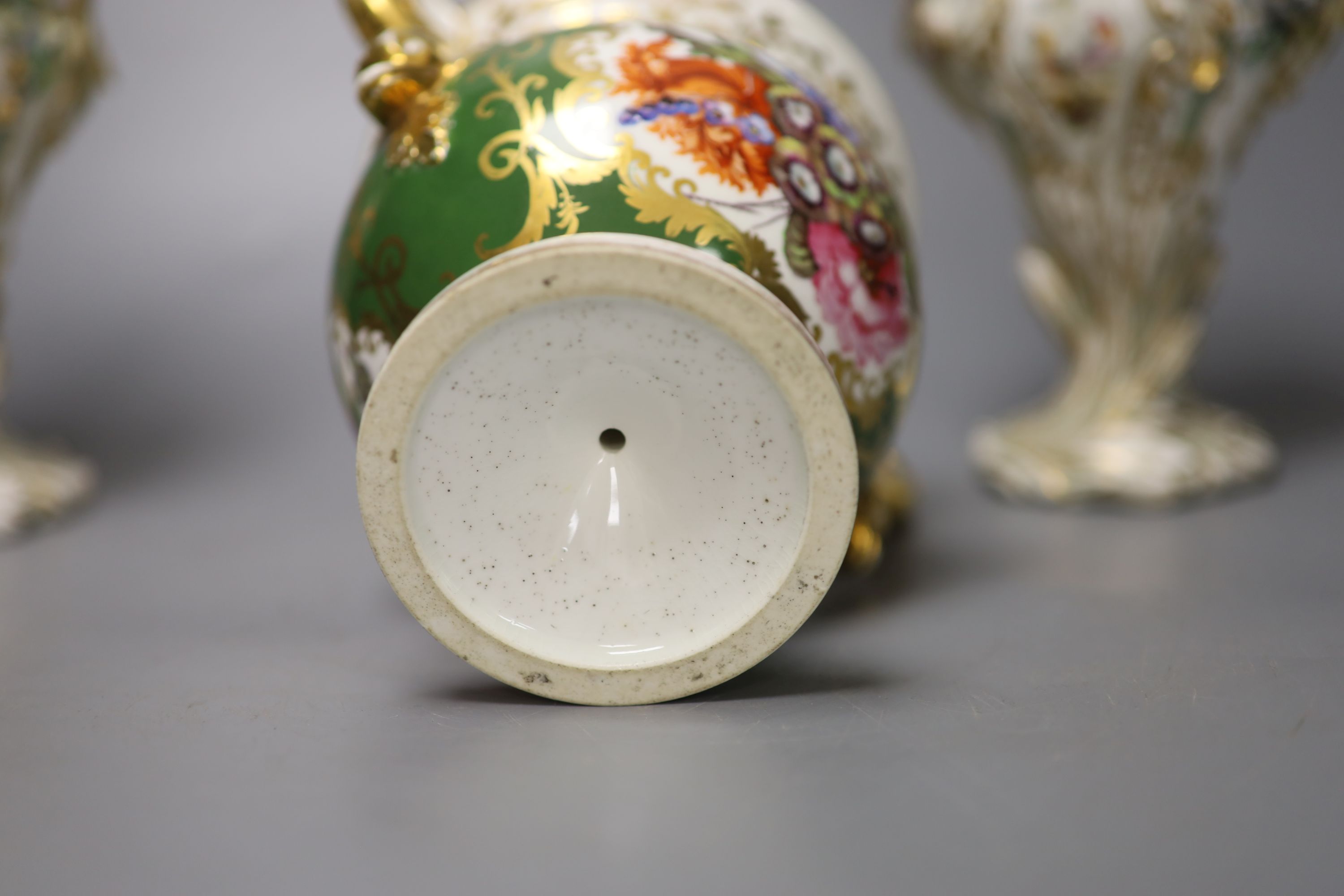 An English porcelain two handled green ground vase and a pair of floral encrusted vases, 20cm